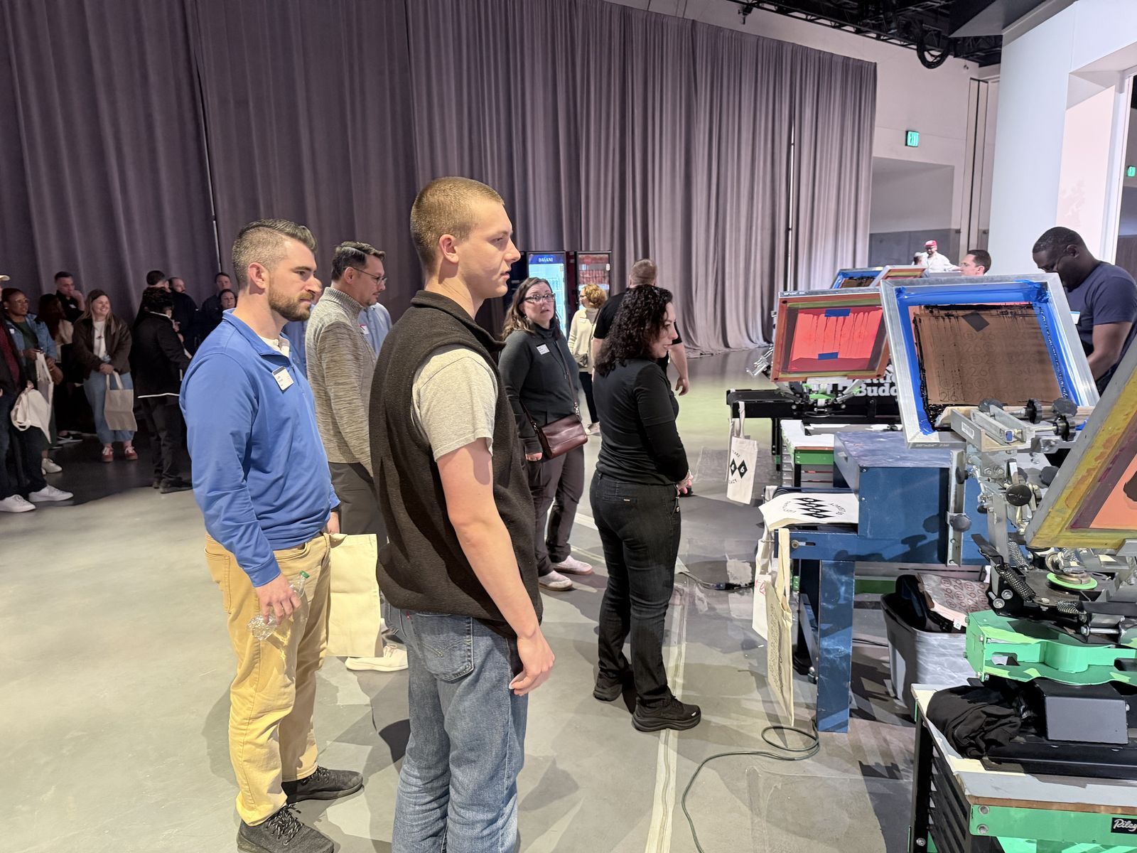 Evening event guests watching operators run side-by-side print stations